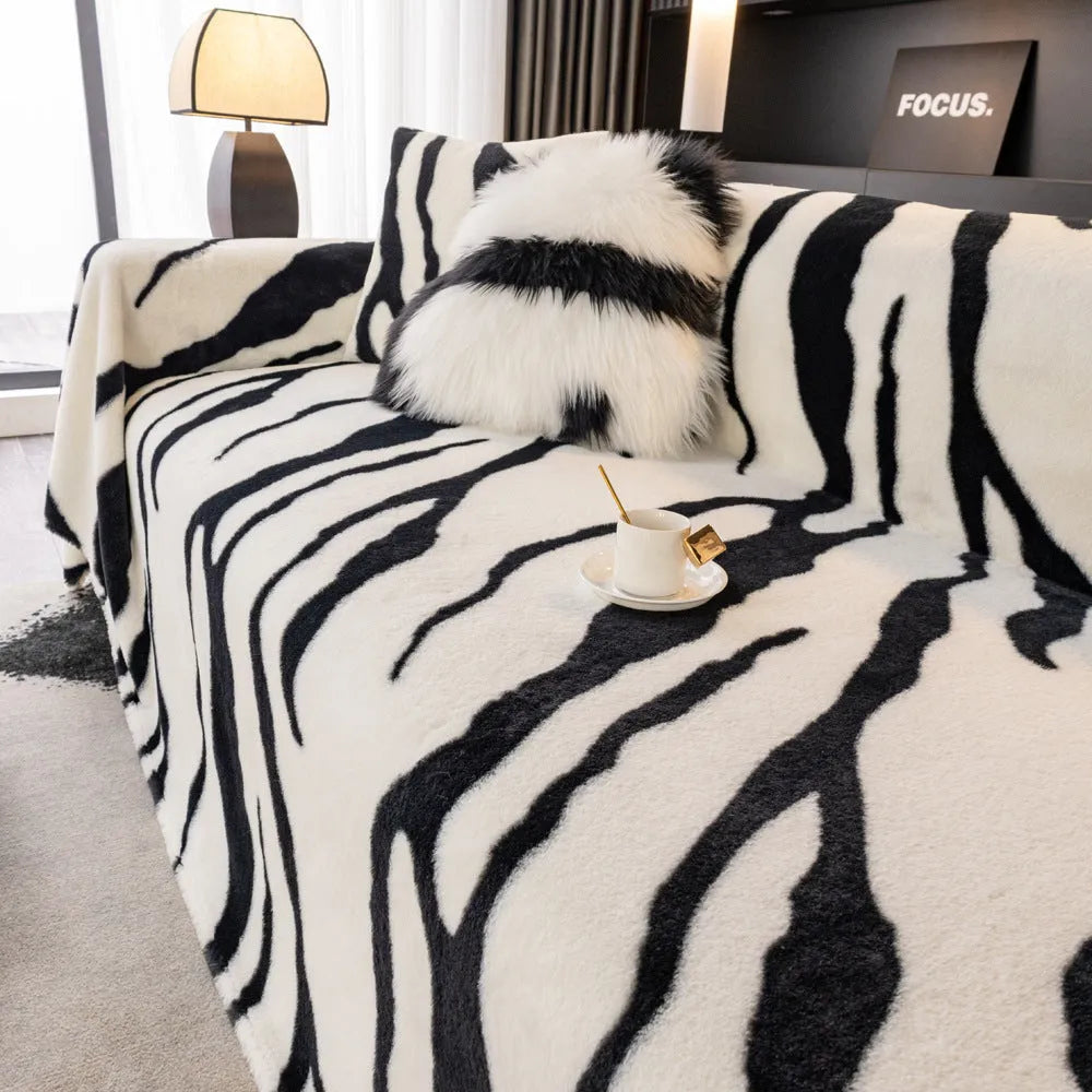 Zebra pattern flannel sofa cover in caramel colour, laid flat showing its size and non-slip textured fabric.