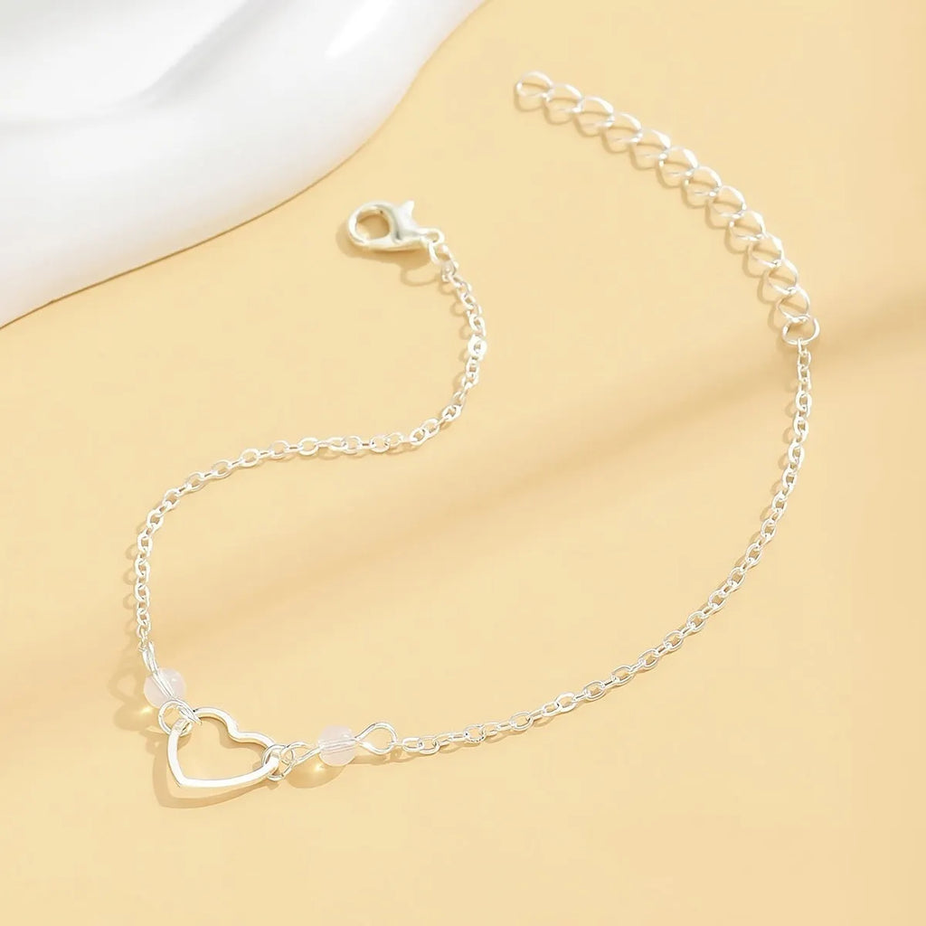 Adjustable women's anklet with heart-shaped pendant in gold or silver finish