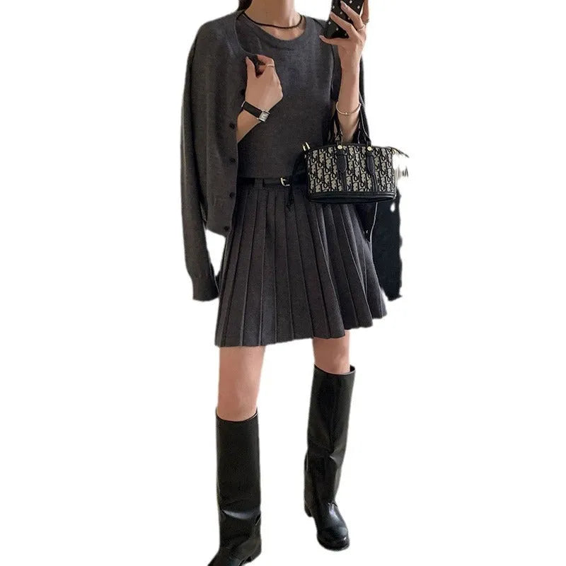 Grey Art Retro style women's knitted vest skirt and long-sleeved cardigan two-piece set with a 3D pattern.