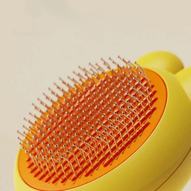 Green self-cleaning pet brush with stainless steel comb and a release button on the handle.