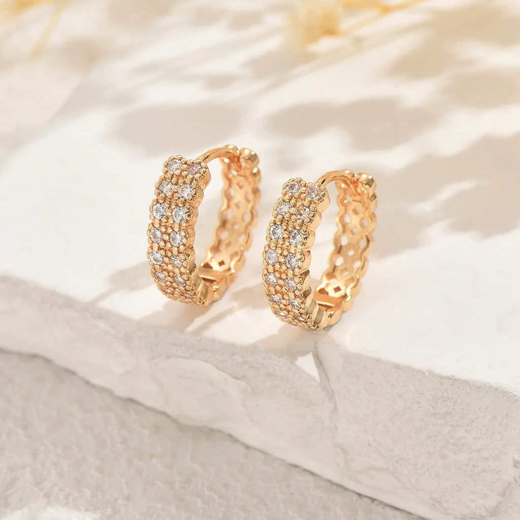 A pair of copper geometry pattern ear studs with round, dot and ring designs in colour DE20288.