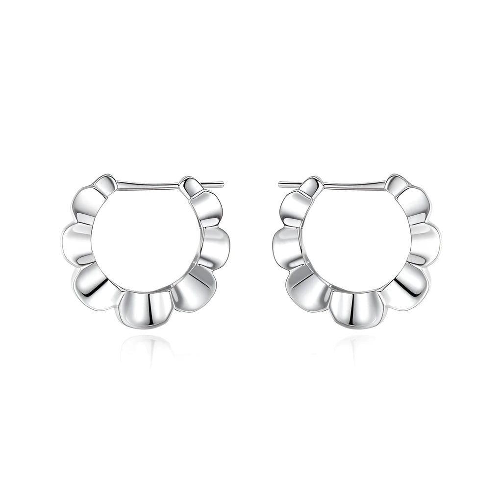 A pair of sterling silver geometric earrings with a round retro design.
