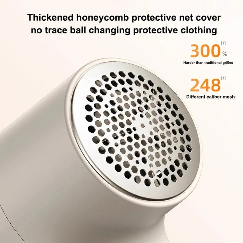 White USB rechargeable electric lint remover and fabric shaver with LED display on a grey background.