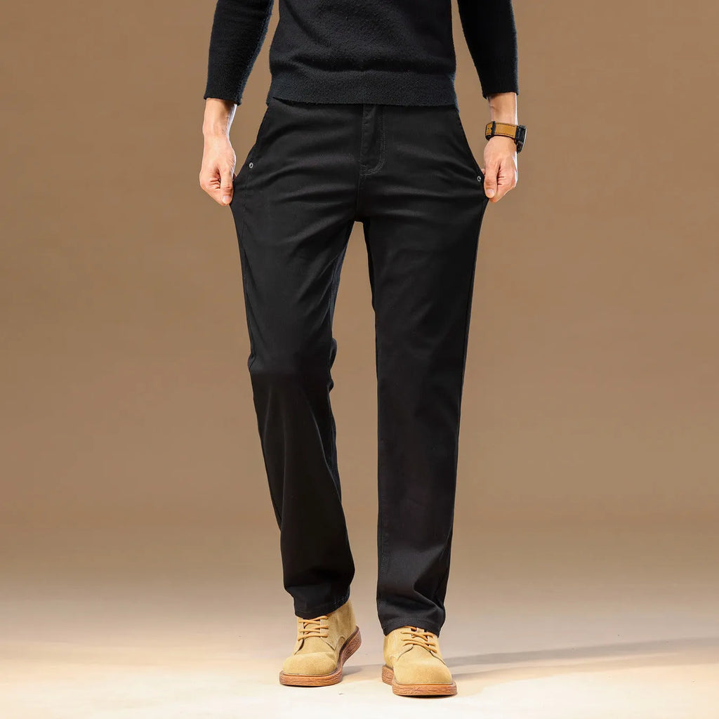 Men's cotton denim loose straight casual trousers in rust red with zip fly and elastic waist, front view