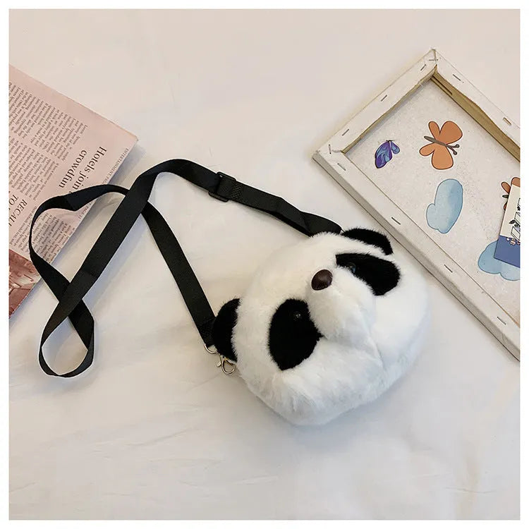 Soft plush panda head crossbody bag with cylindrical shape and outer pocket.