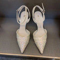 A pair of women's black hollow high heels with a red sole, stiletto heel, and pointed toe.