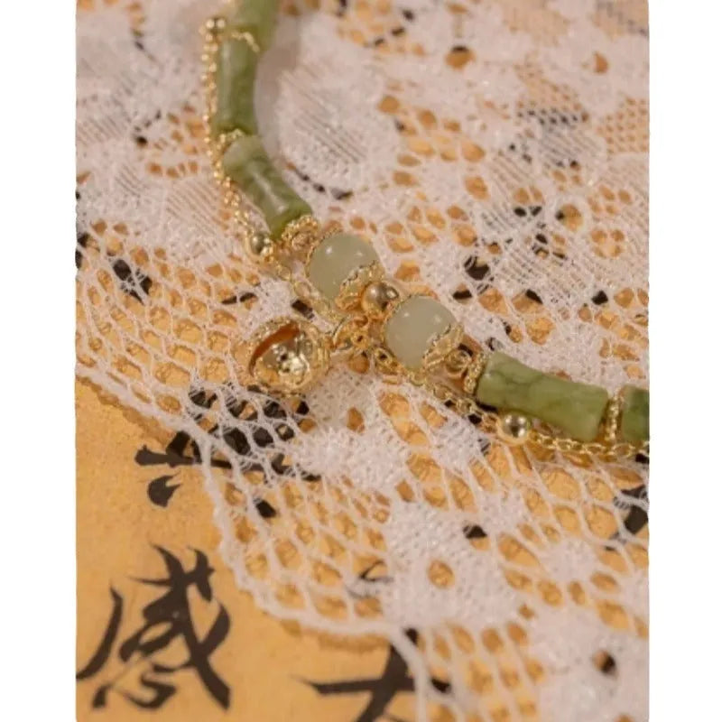 Women's natural Hetian jade bamboo bracelet on white background, adjustable 15+3 cm size