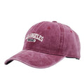 Retro style acrylic peaked cap with distressed letter embroidery on the front, shown in beige colour.