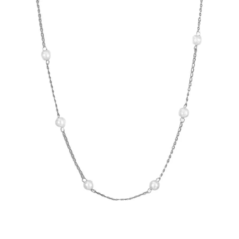 Pearl necklace with copper geometric pendant and ball bead chain on dark background