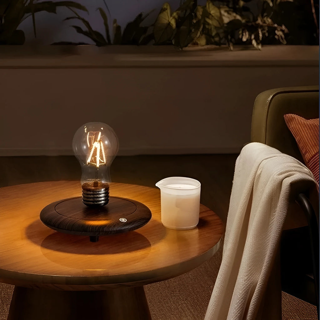 Creative small iron suspension bulb night lamp on a black woodgrain base for desktop decoration.
