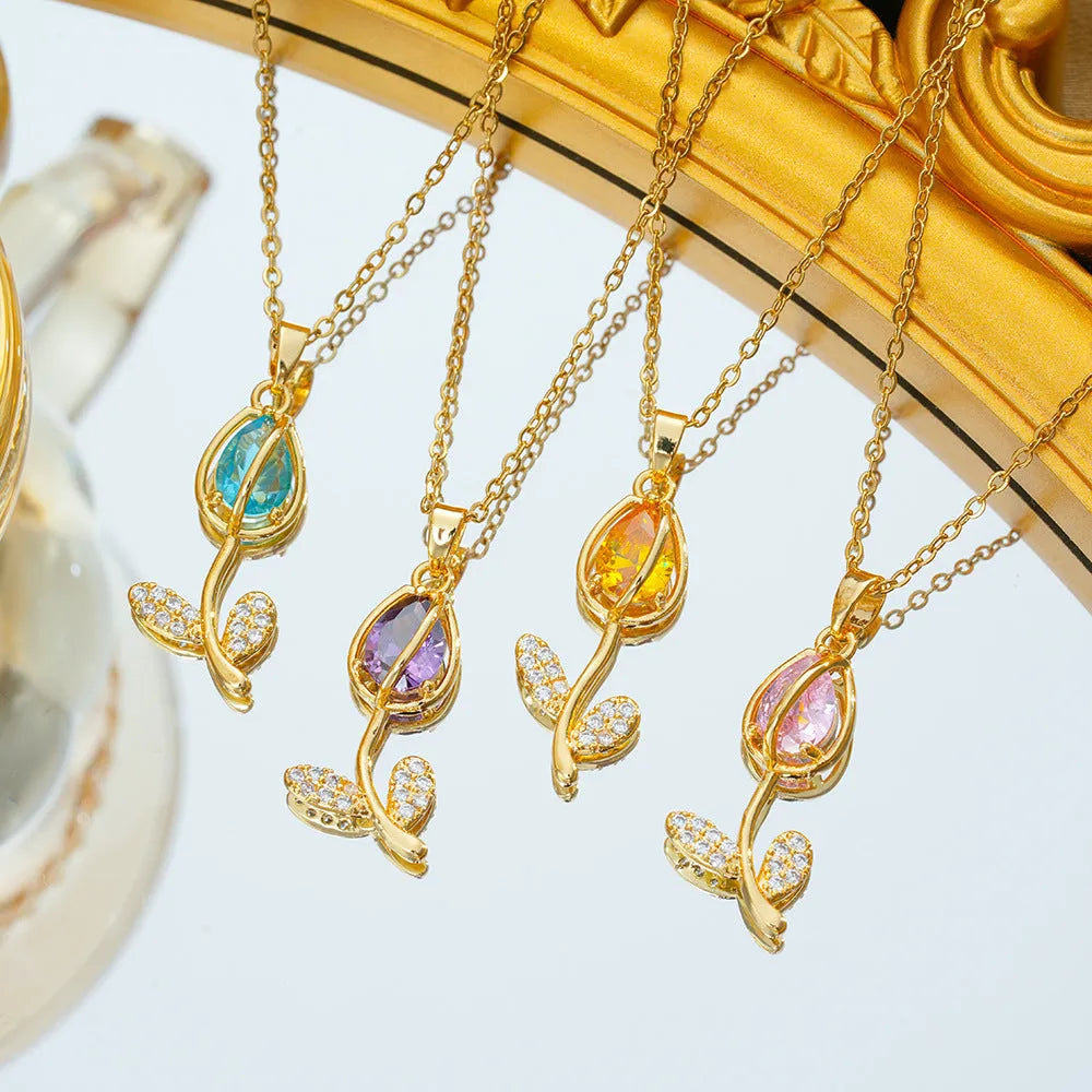 Gold-toned titanium steel necklace with a floral tulip pendant on an O-ring chain.