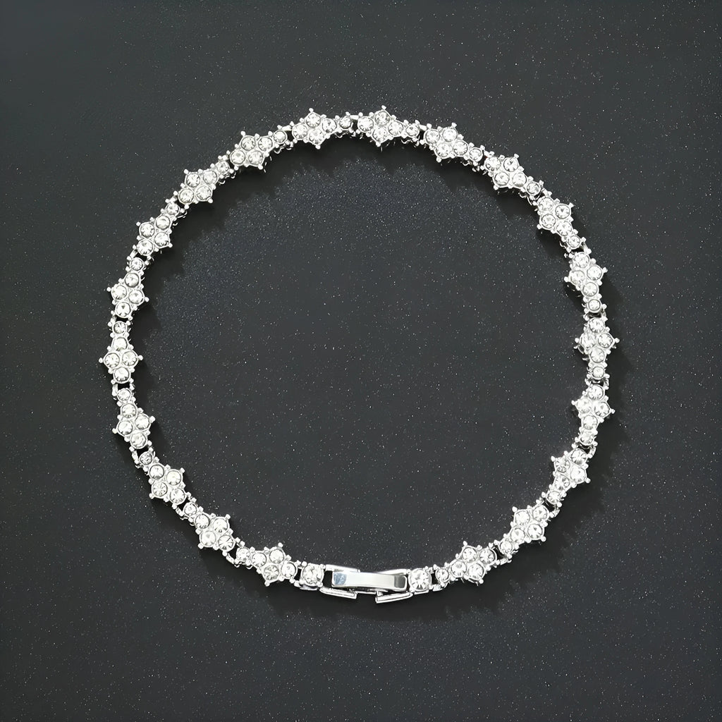 Flower-shaped cross tennis chain bracelet in gold alloy with diamond geometry pattern close-up
