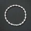 Flower-shaped cross tennis chain bracelet in gold alloy with diamond geometry pattern close-up