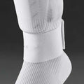 Red elastic rubber strap for securing football shin guards, shown at approximate size.