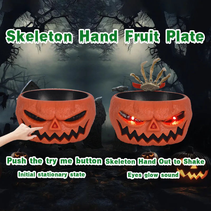 Plastic Halloween pumpkin candy bowl with motion activated skeleton hand, glowing red eyes, in Khaki colour, on a table with candy.