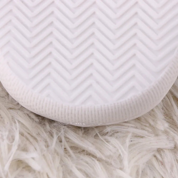 White cartoon pattern plush toe holder slippers with a non-slip rubber sole.
