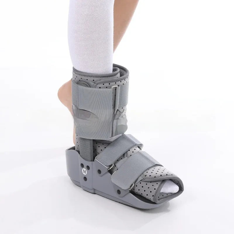 Grey and black Achilles tendon rehabilitation boot with adjustable straps and a rigid plastic shell