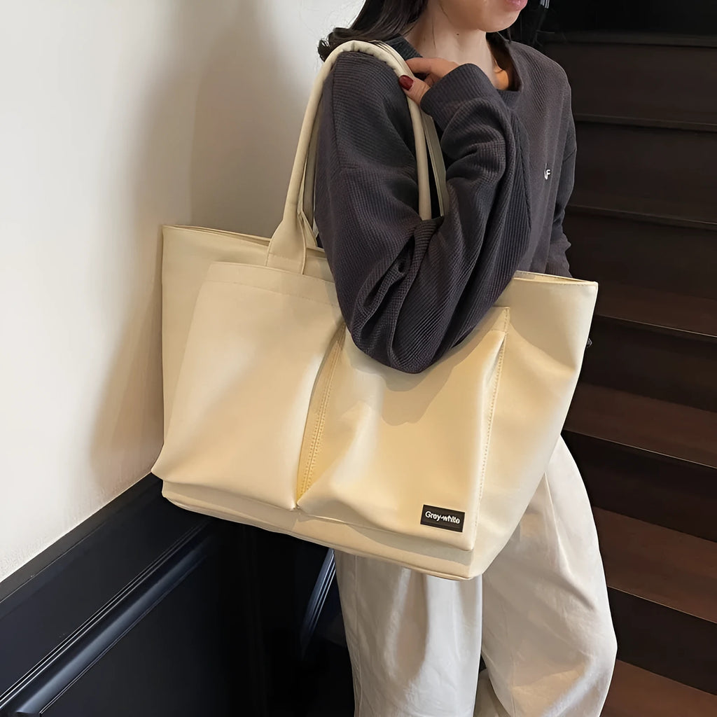 Sporty green PU shoulder bag with adjustable straps showing expandable compartments.