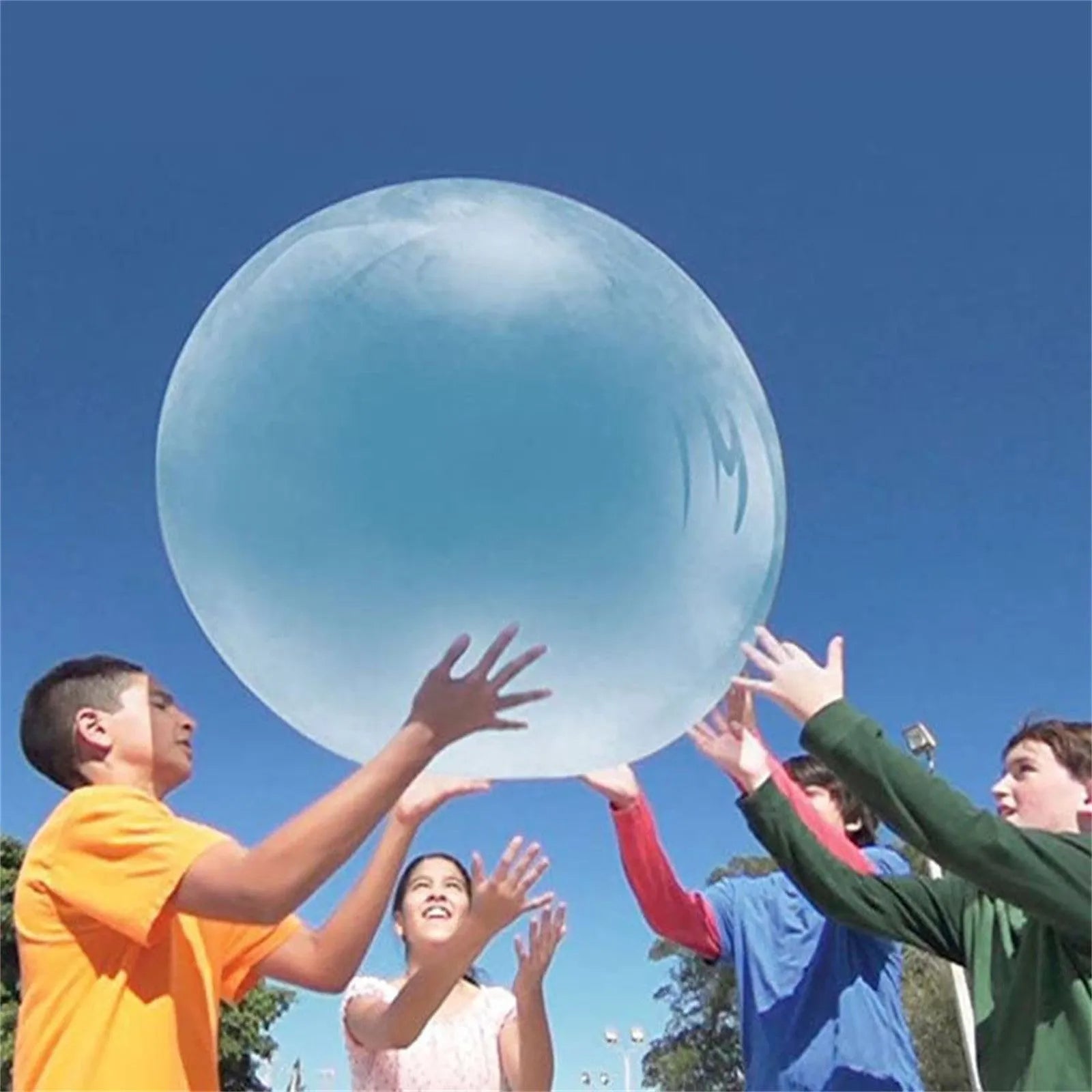 Large pink TPR inflatable bouncy ball for children's outdoor play, shown with a pump