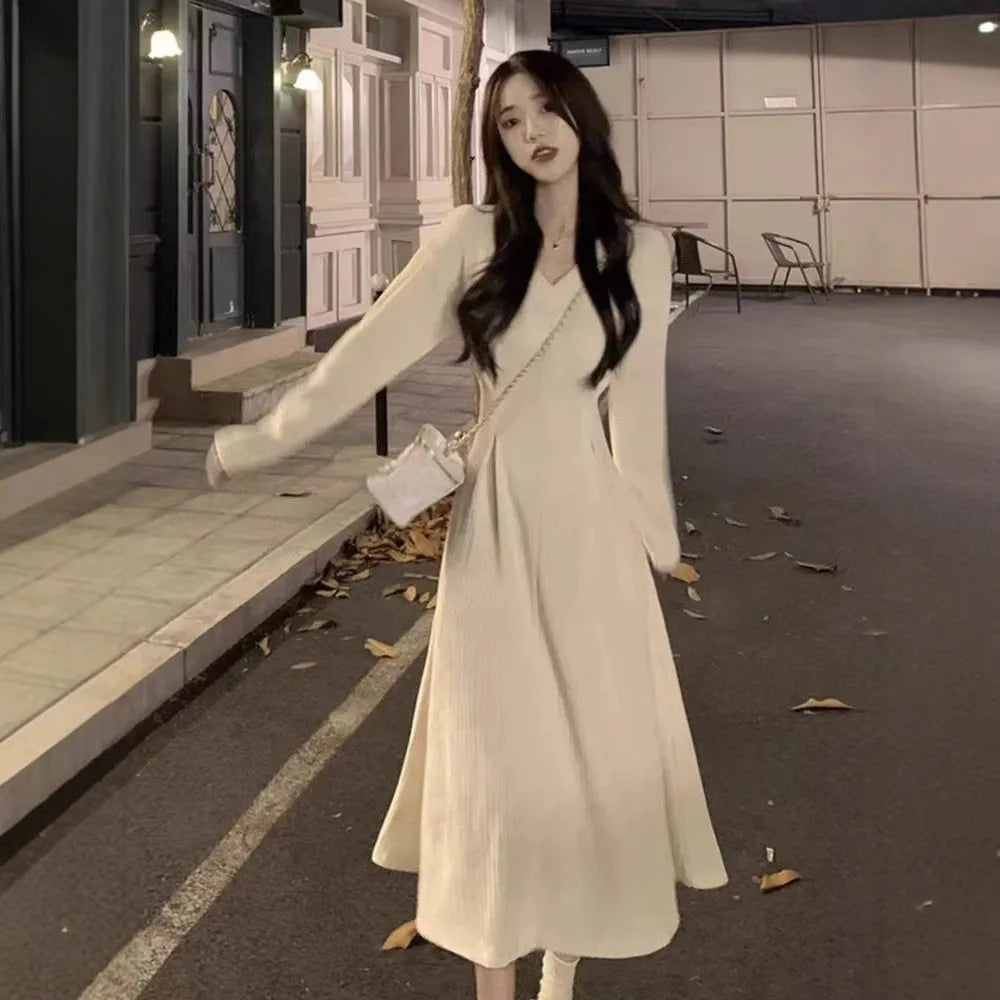Women's knitted V-neck dress with princess sleeves and long skirt in Milky White or Black.