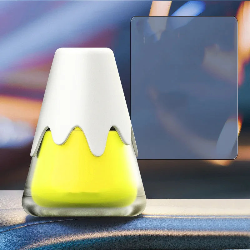 Glass jar car air freshener diffuser with fragrance paste, shown next to a ruler for scale.