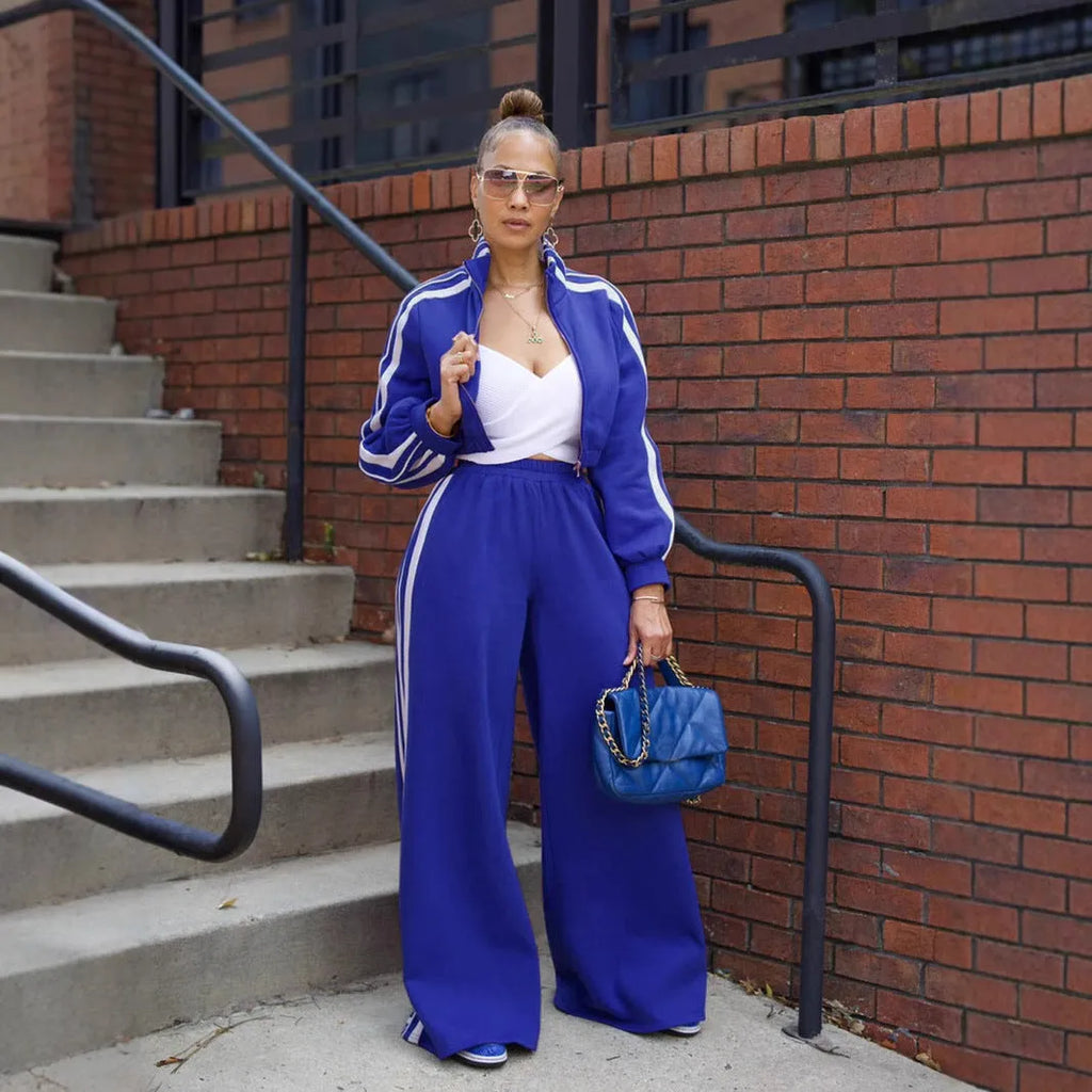 Grey striped two-piece sweater set with a zippered top and matching trousers on a model.
