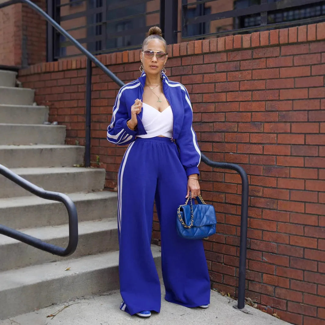 Grey striped two-piece sweater set with a zippered top and matching trousers on a model.