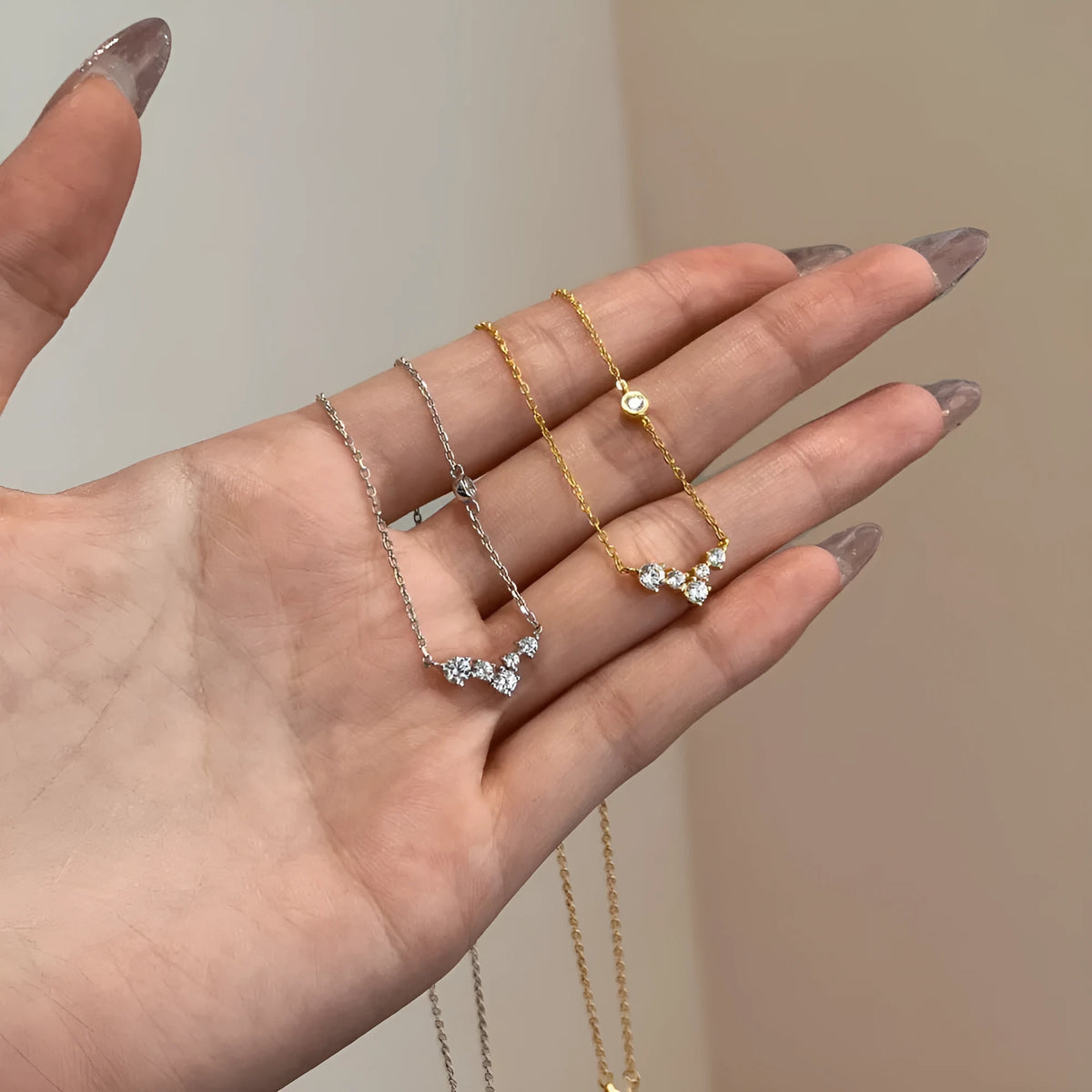 925 silver clavicle chain necklace with geometric pendant in electroplated gold finish on a woman's neck