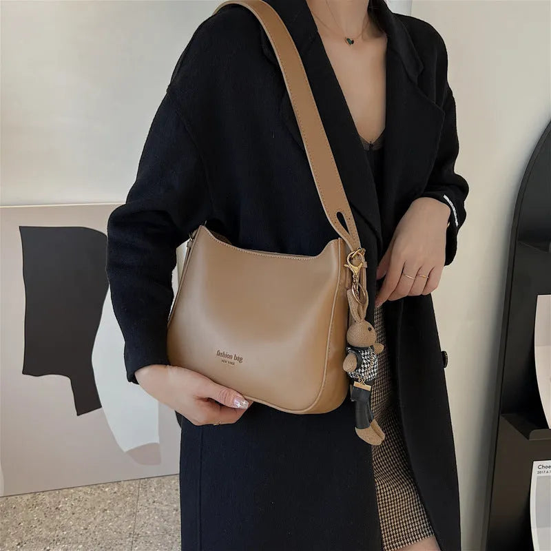 PU shoulder messenger bag in horizontal square shape with slit pocket available in black colour