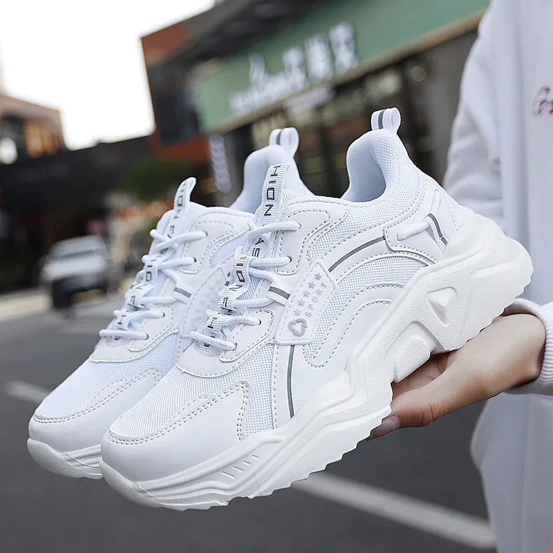 Women's thick-soled casual sports shoes with mesh upper and buckle detailing in black colour