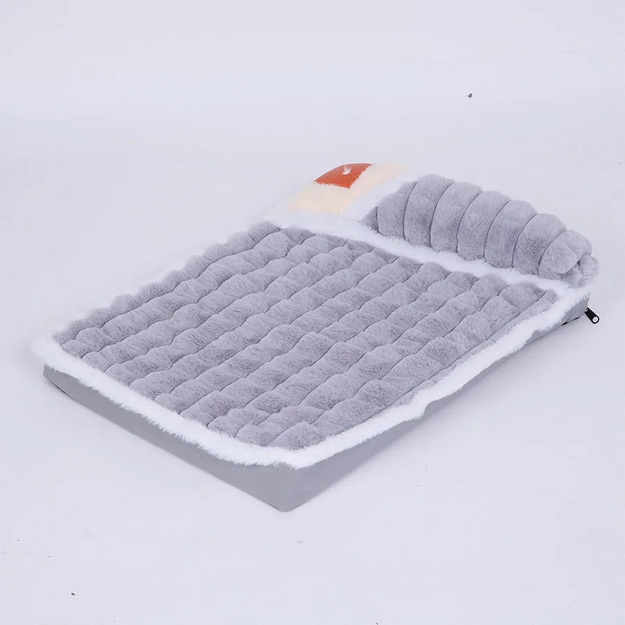 Large rectangular dog bed mat with a removable cover in a grey colour on a wooden floor.
