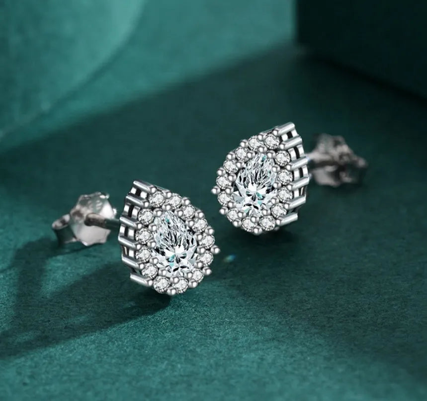Women's silver water drop shaped ear studs made from 925 sterling silver with diamond treatment
