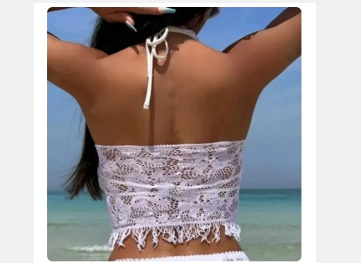 Women's white lace bikini top with matching tassel skirt two-piece swimsuit set on beach