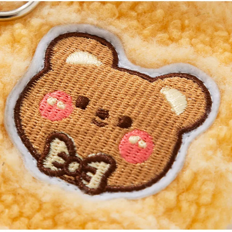 Yellow striped lambskin fleece dog clothing with bear patch and leash ring on a small dog