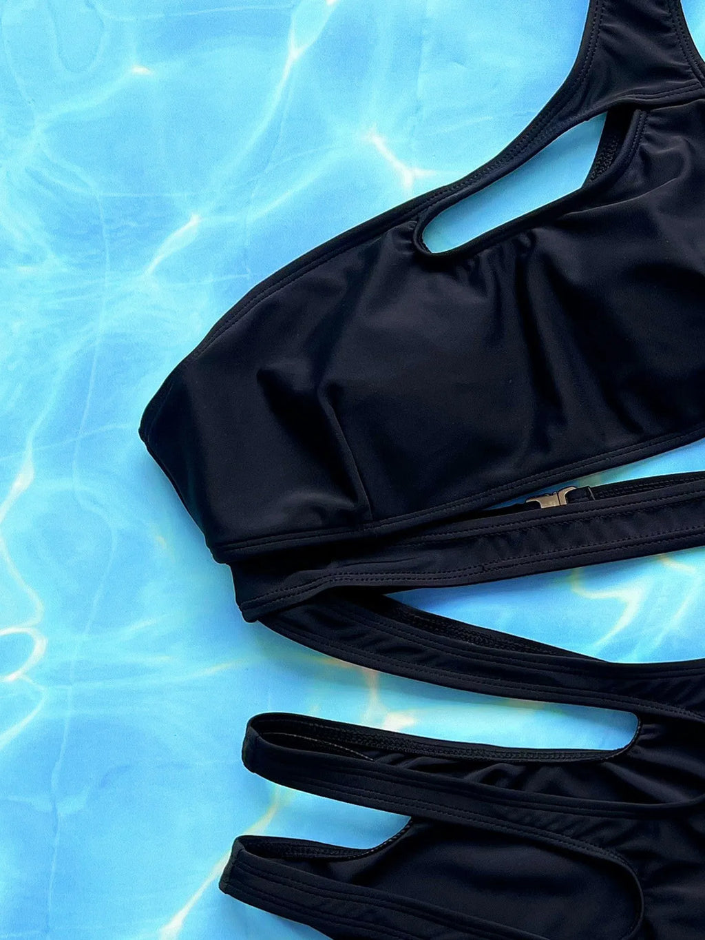 Black women's one-piece swimsuit with hollow out strap detail shown front view