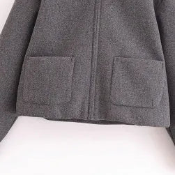 Women's gray PU jacket with shirt-collar, zip front, and long sleeves on a model