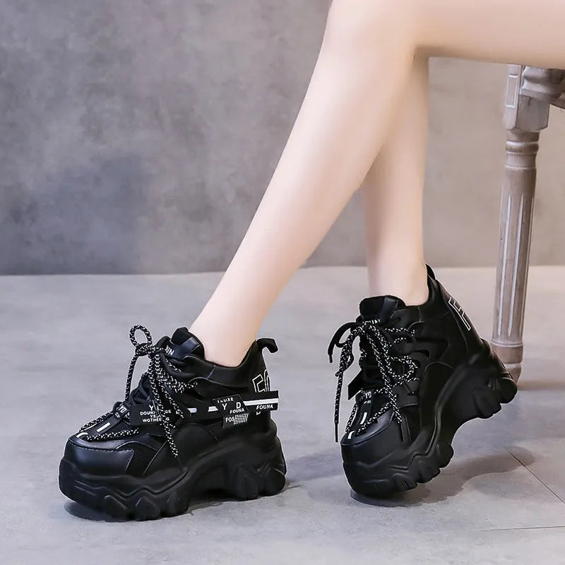 Women's white and black breathable mesh platform sports shoes with cross-strap and rubber sole.