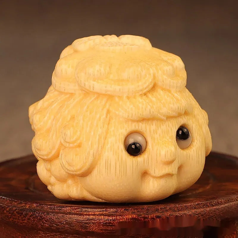 Solid bamboo carving of a cute golden toad princess ornament, 5 cm tall, on a plain background.