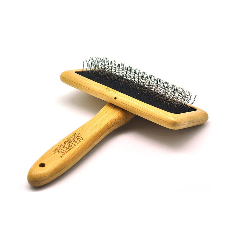 Pet grooming bamboo wood air cushion needle comb in original bamboo colour with steel pins, shown on a table
