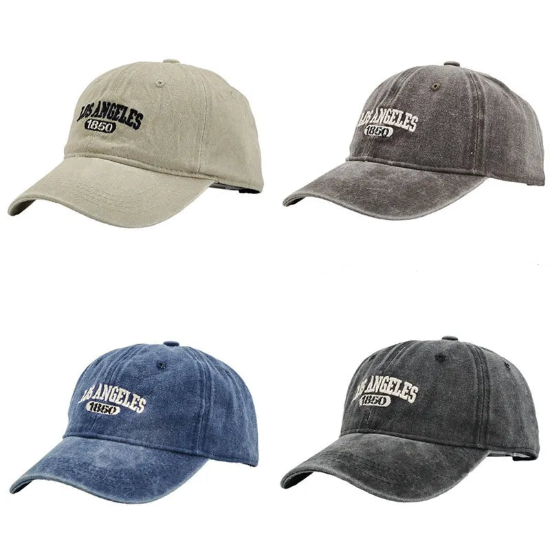 Retro style acrylic peaked cap with distressed letter embroidery on the front, shown in beige colour.