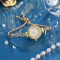 Round women's quartz watch on alloy bracelet with diamond accents and gold finish