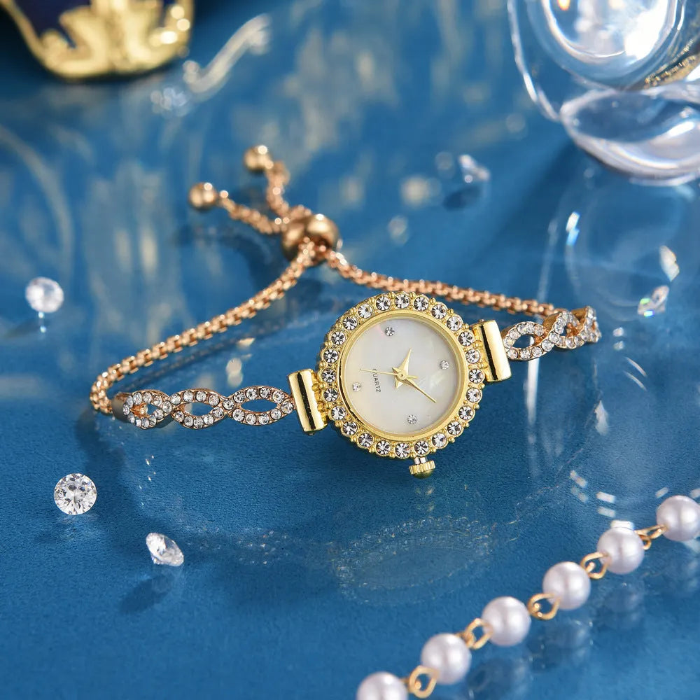 Round women's quartz watch on alloy bracelet with diamond accents and gold finish