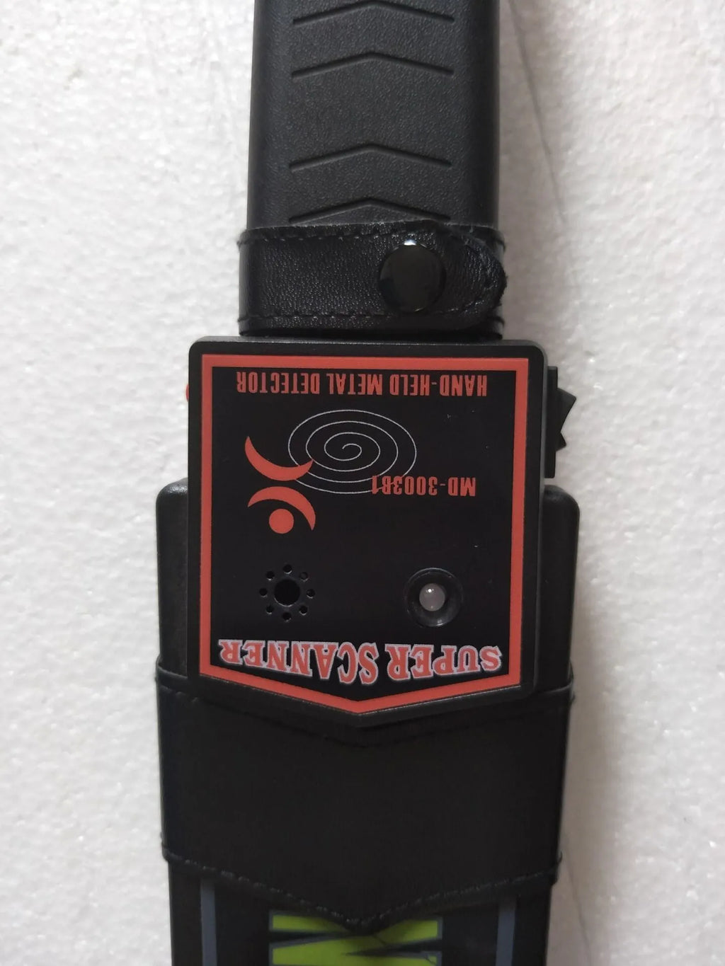 Black handheld metal detector with leather carrying case, 410mm length, for security screening