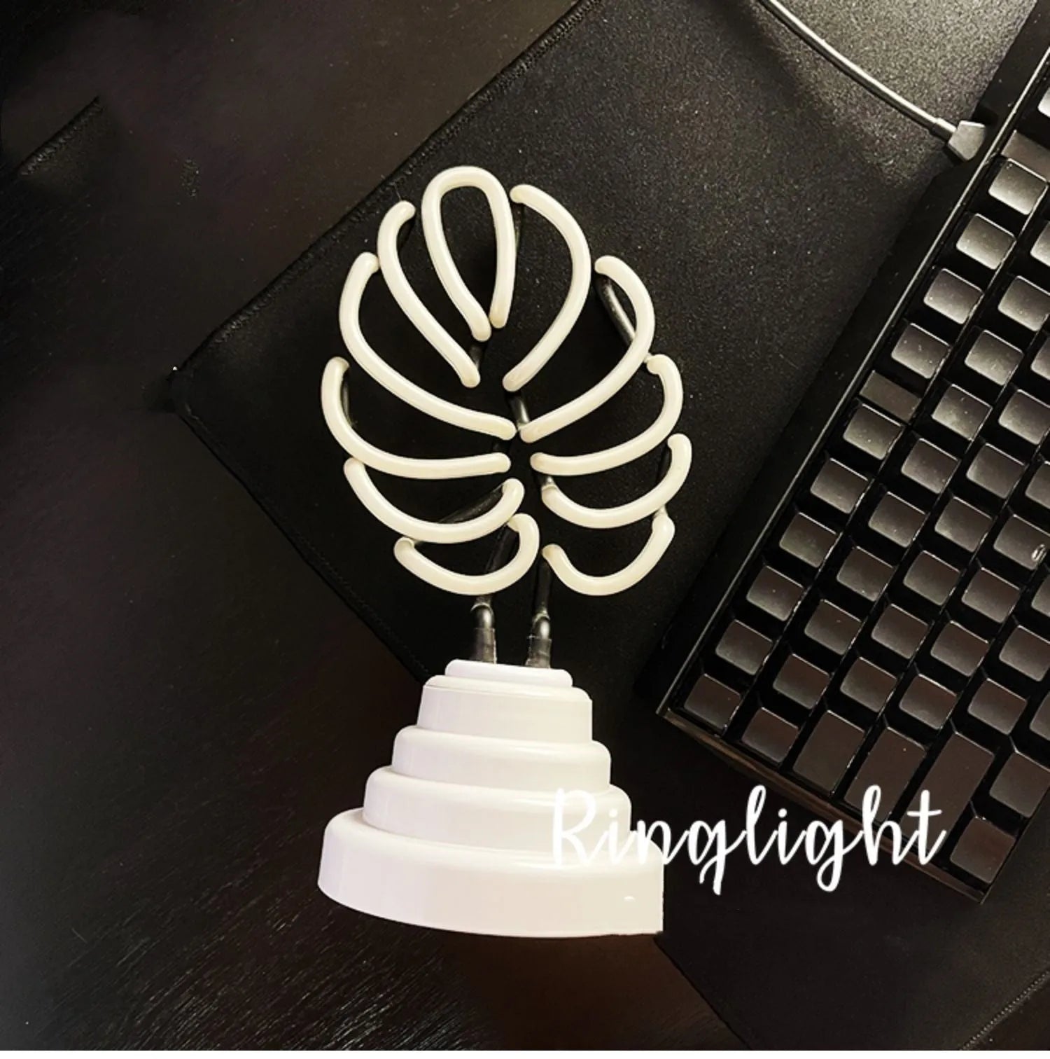 Minimalist bamboo-shaped desktop lamp with USB cable and green illumination