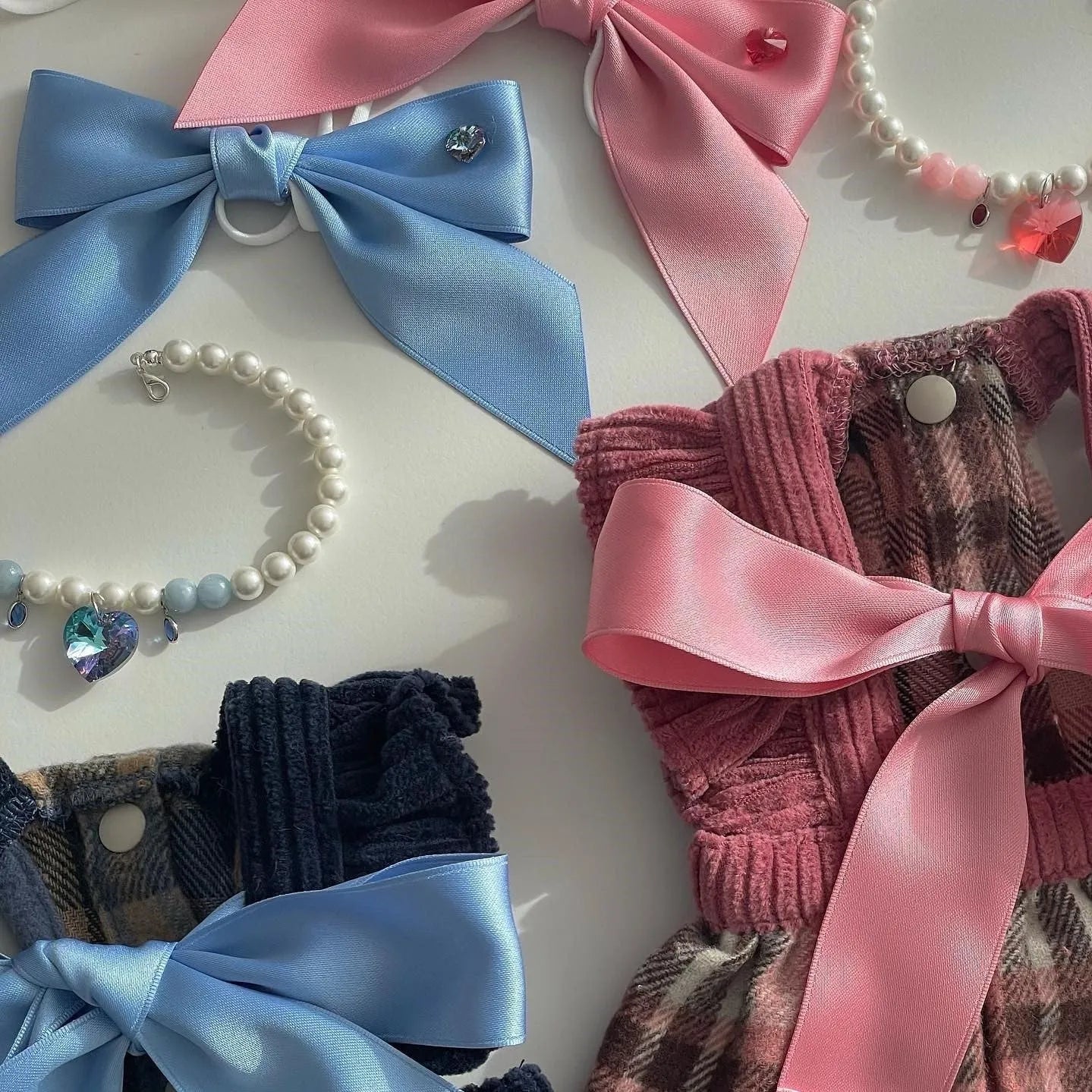 Blue princess-style adjustable bow hair band for dogs on a white background.