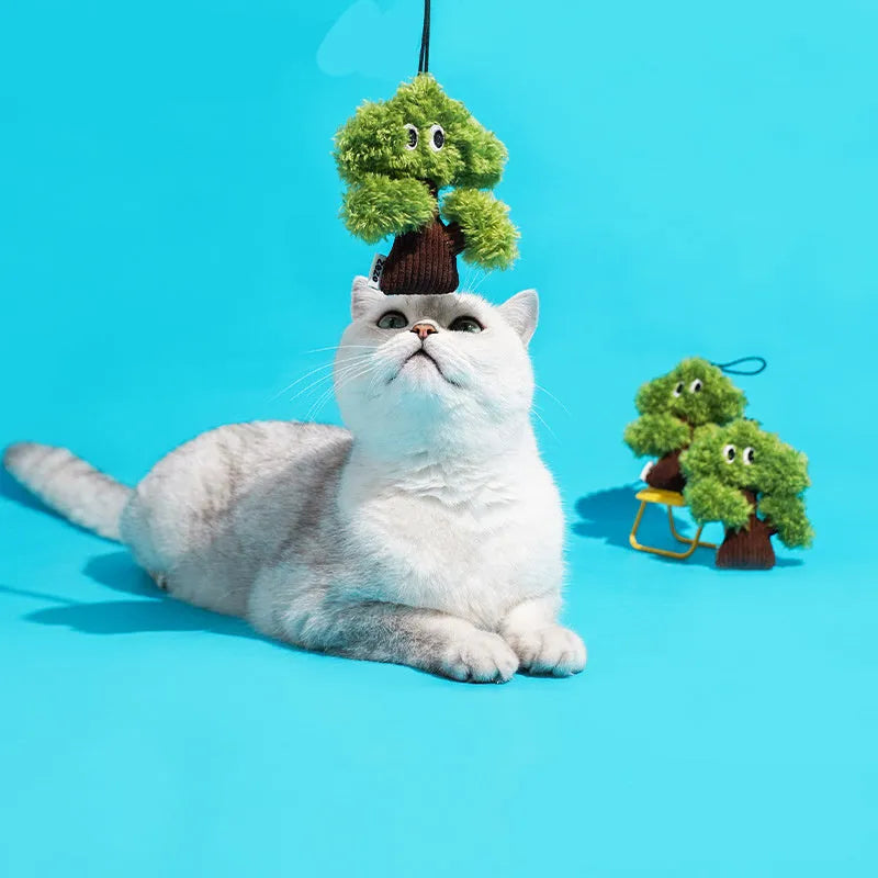 Pine tree shaped hanging cat toy with textured surface and bag of catnip.