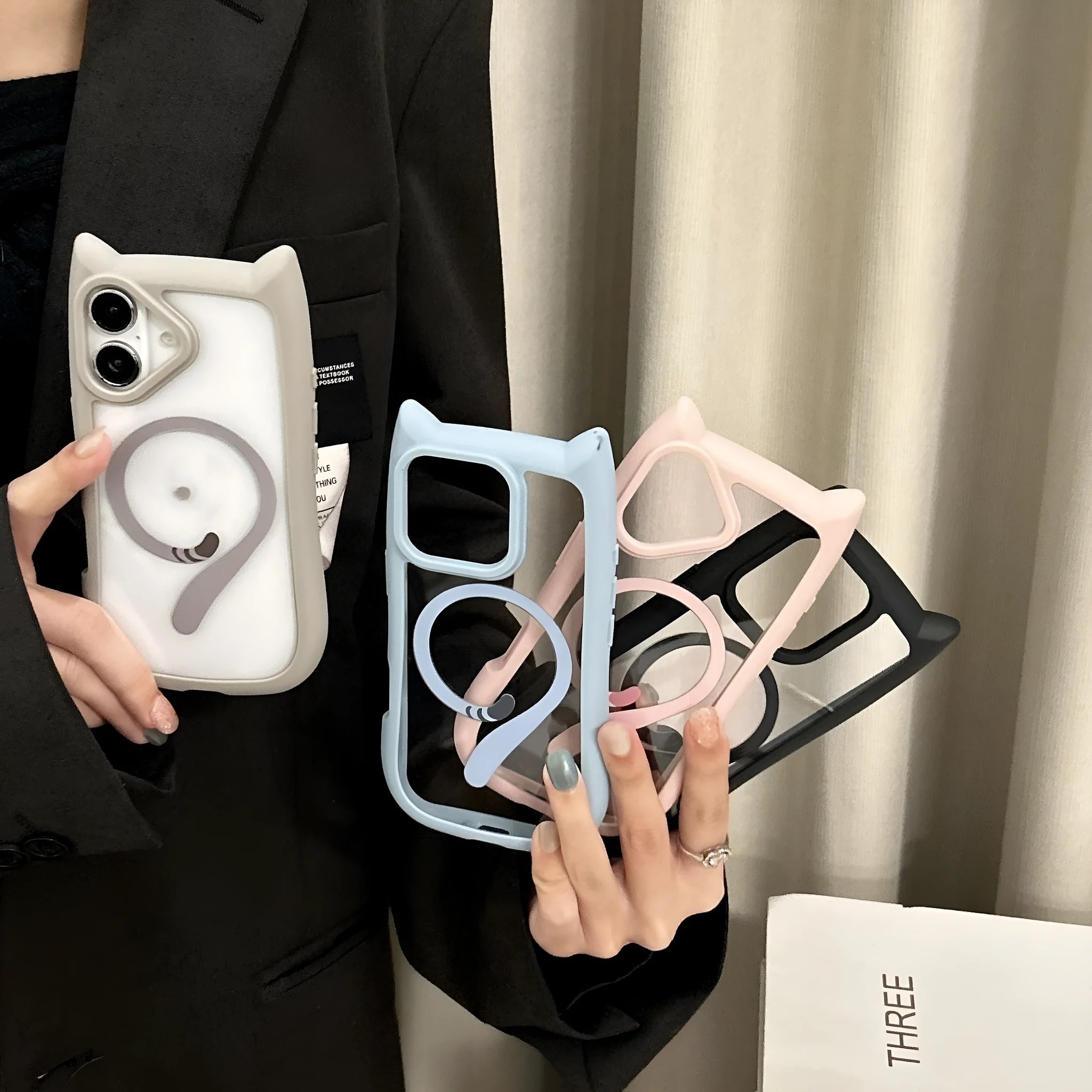 Transparent acrylic and TPU phone case for iPhone 17 models in black, blue, grey, and pink colour options.