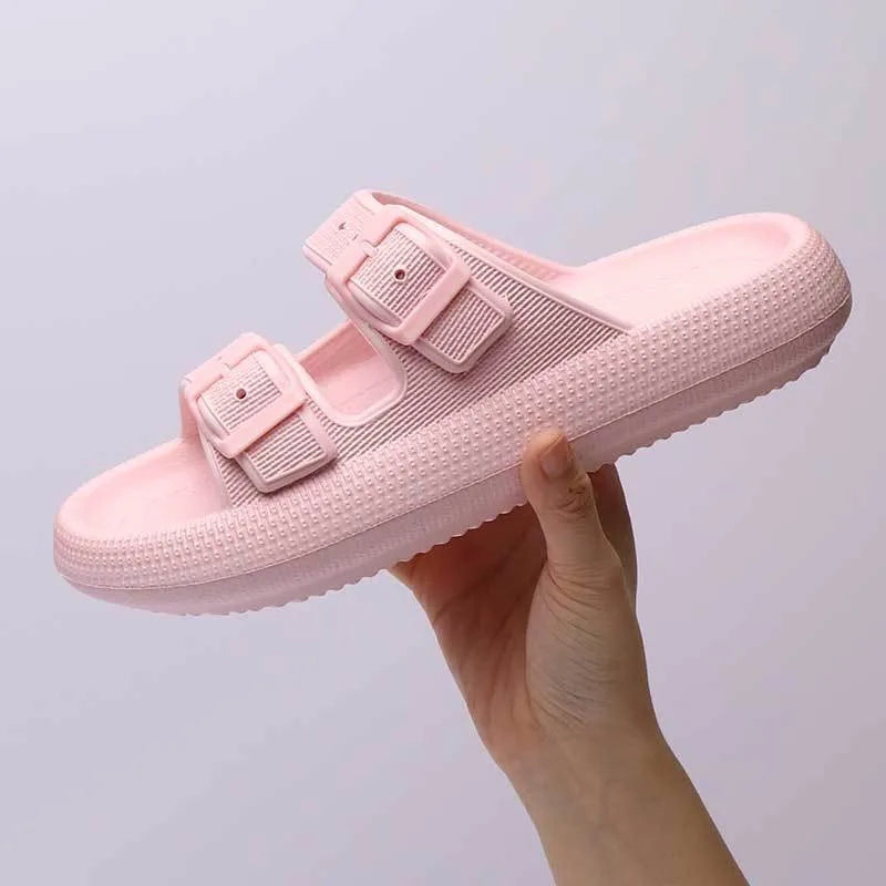 Women's beige platform slippers with buckle fastening and round toe on a flat surface