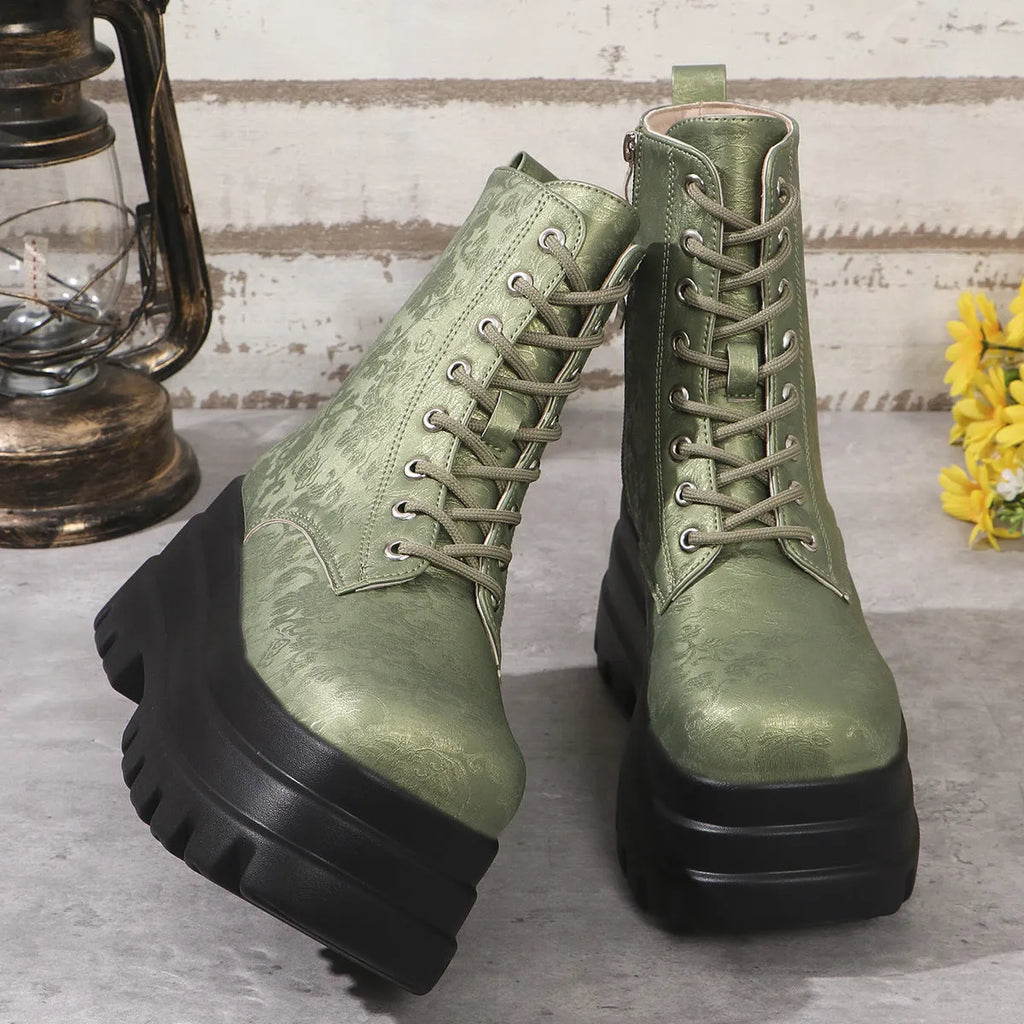 Women's black platform Martin boots with patchwork detail and side zip on a white background.