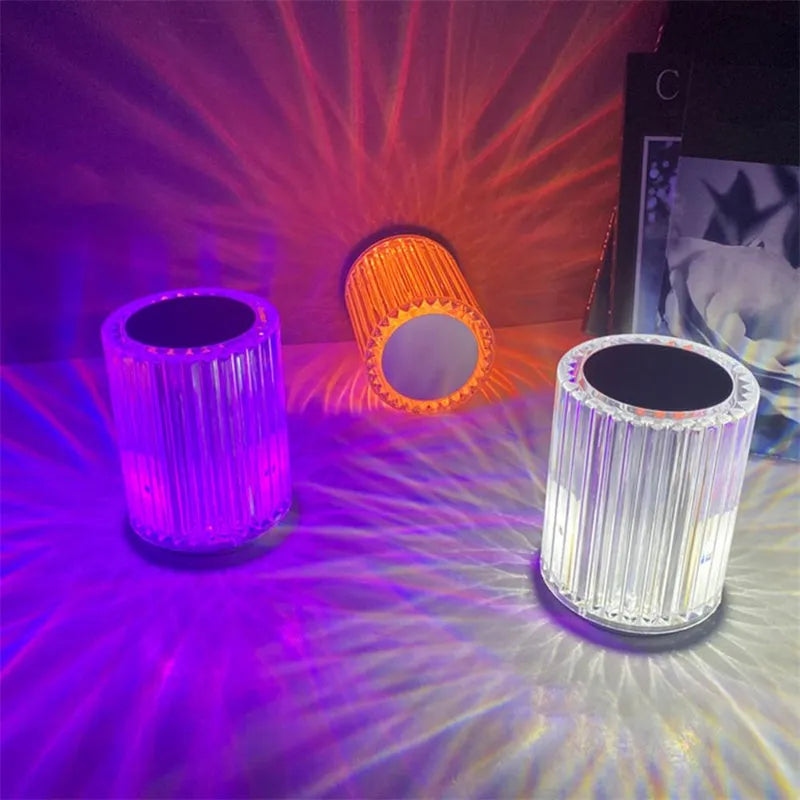 Compact acrylic crystal LED table lamp with RGB colours and remote control on a desk